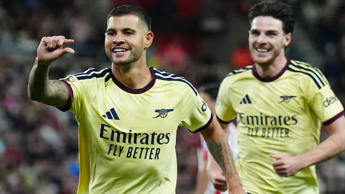 Bruno Guimaraes celebrates in Arsenal yellow with Declan Rice behind him