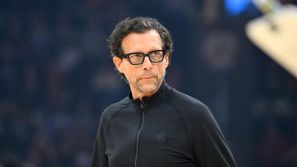 Atlanta Hawks coach Quin Snyder wears glasses and a black quarter-zip top