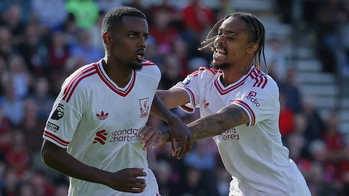 Liverpool striker Alexander Isak is congratulated by a teammate in Liverpool’s white away kit after scoring at Bournemouth