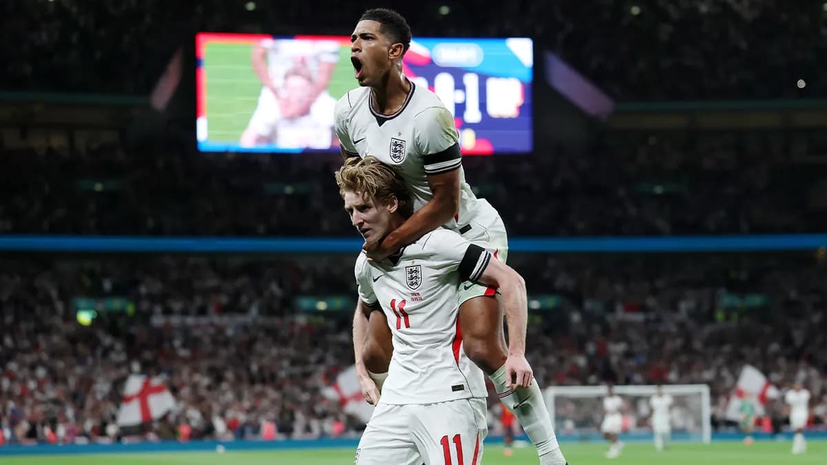 England’s Jude Bellingham leaps onto Anthony Gordon’s back to celebrate a goal against Spain at a packed Wembley Stadium