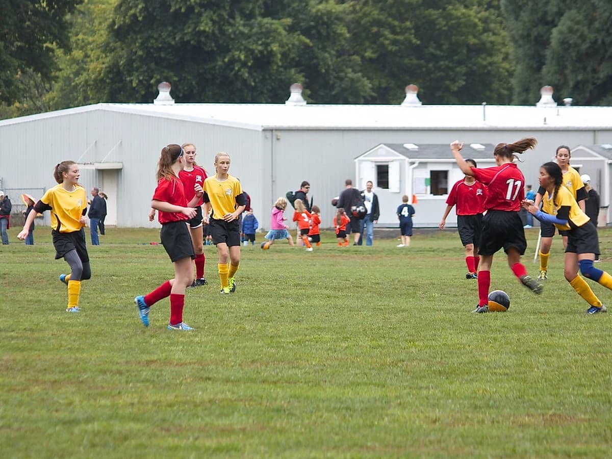 Football match action shot, midfielder controlling the ball