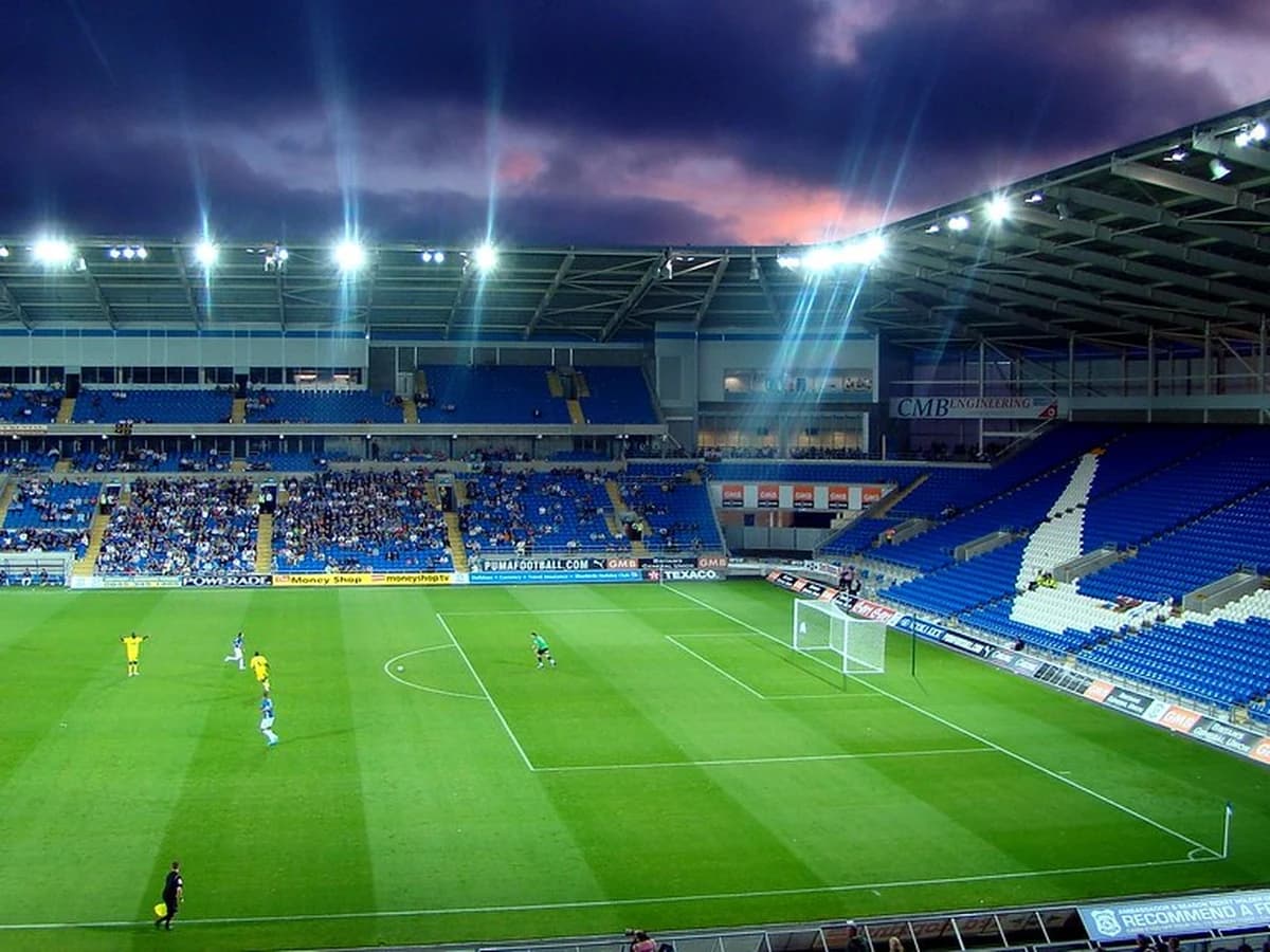 Football stadium under lights, wide-angle shot before kickoff