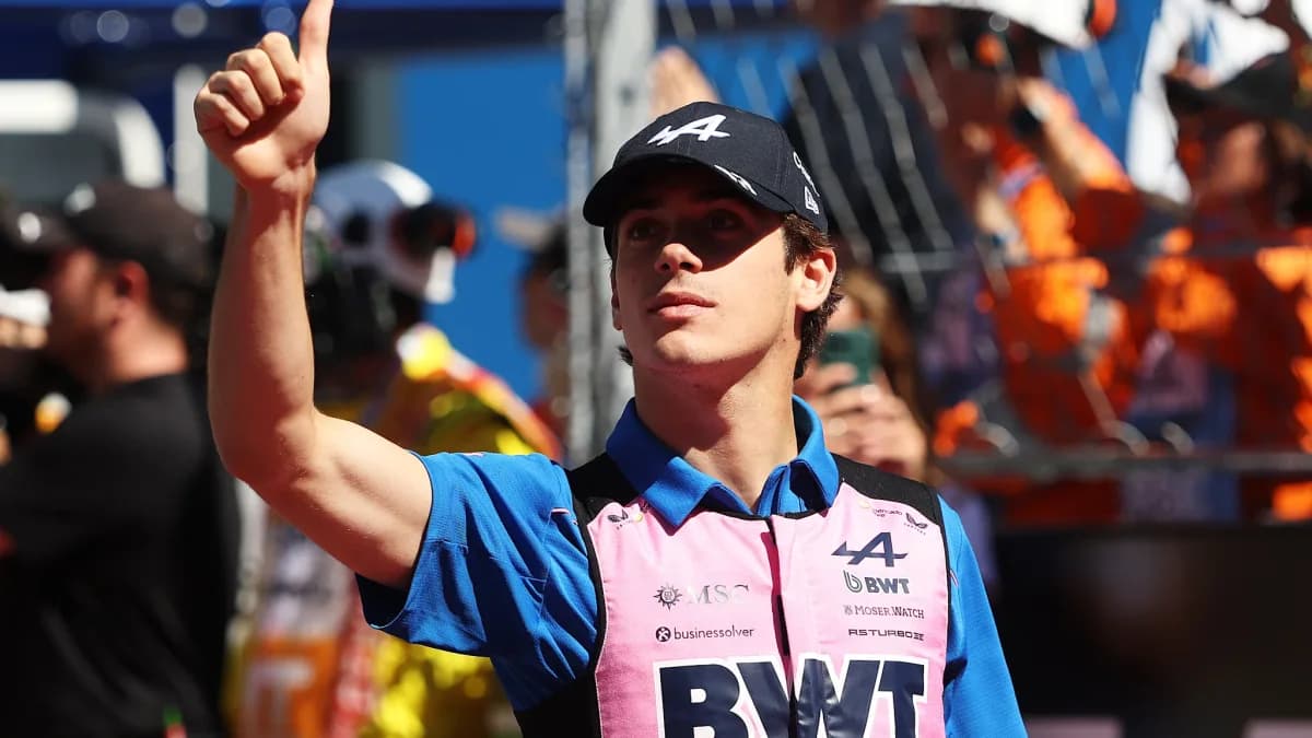 Franco Colapinto gives a thumbs-up in his pink and blue Alpine team shirt