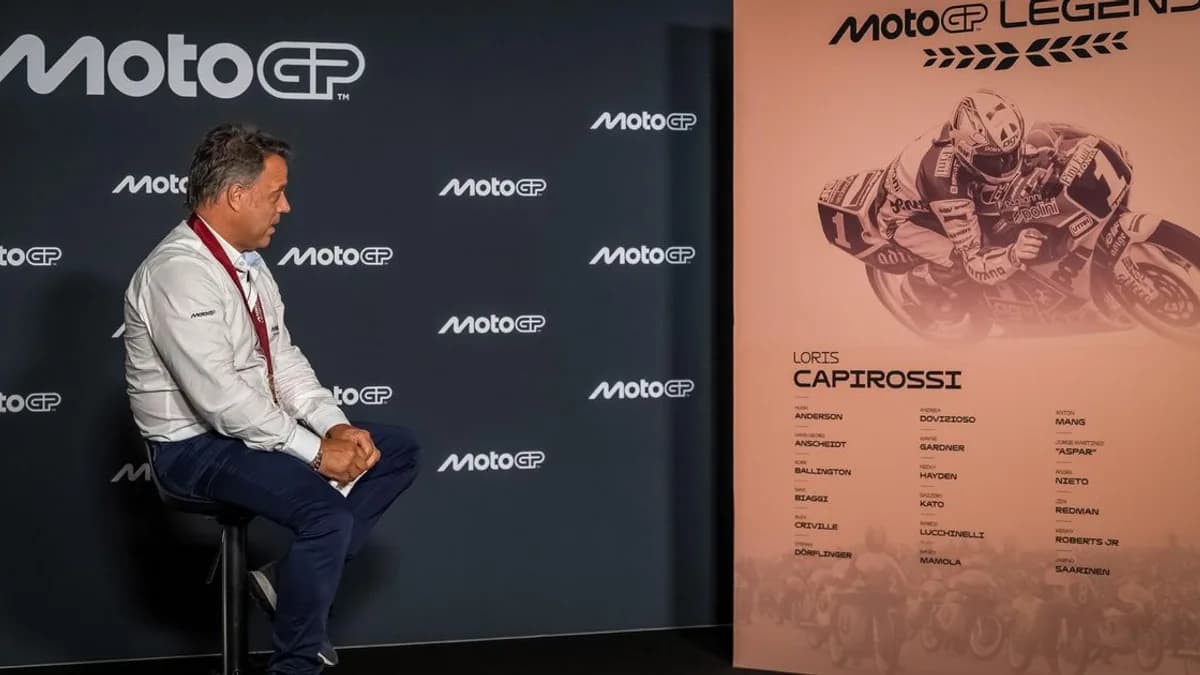 A MotoGP Legend presentation takes place beside a display of Loris Capirossi career statistics