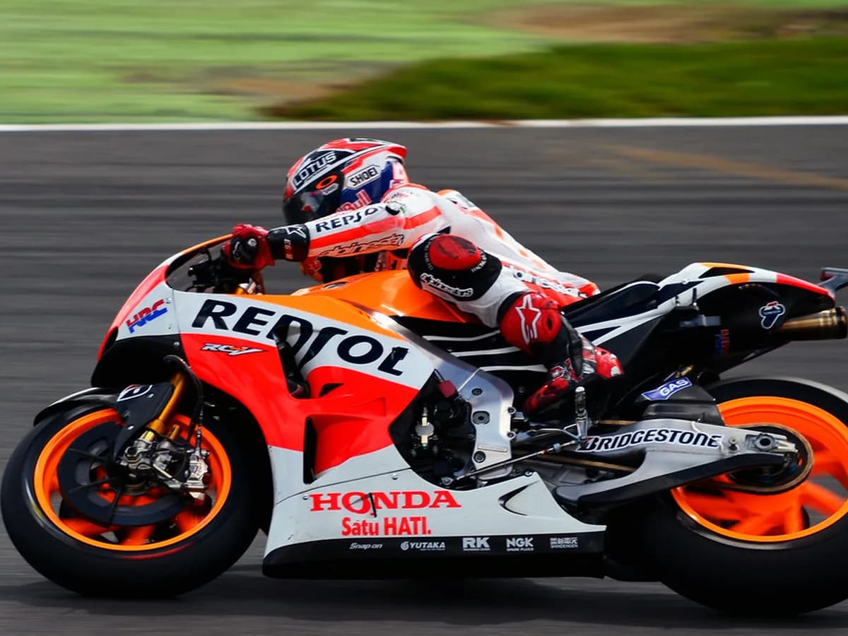 MotoGP rider leaning into a fast corner at full lean angle