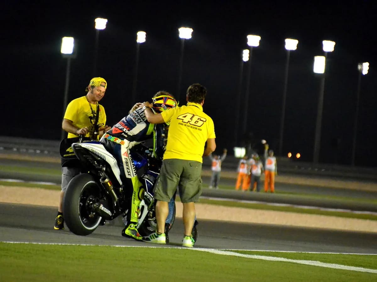 MotoGP rider celebrating with fans after a podium finish