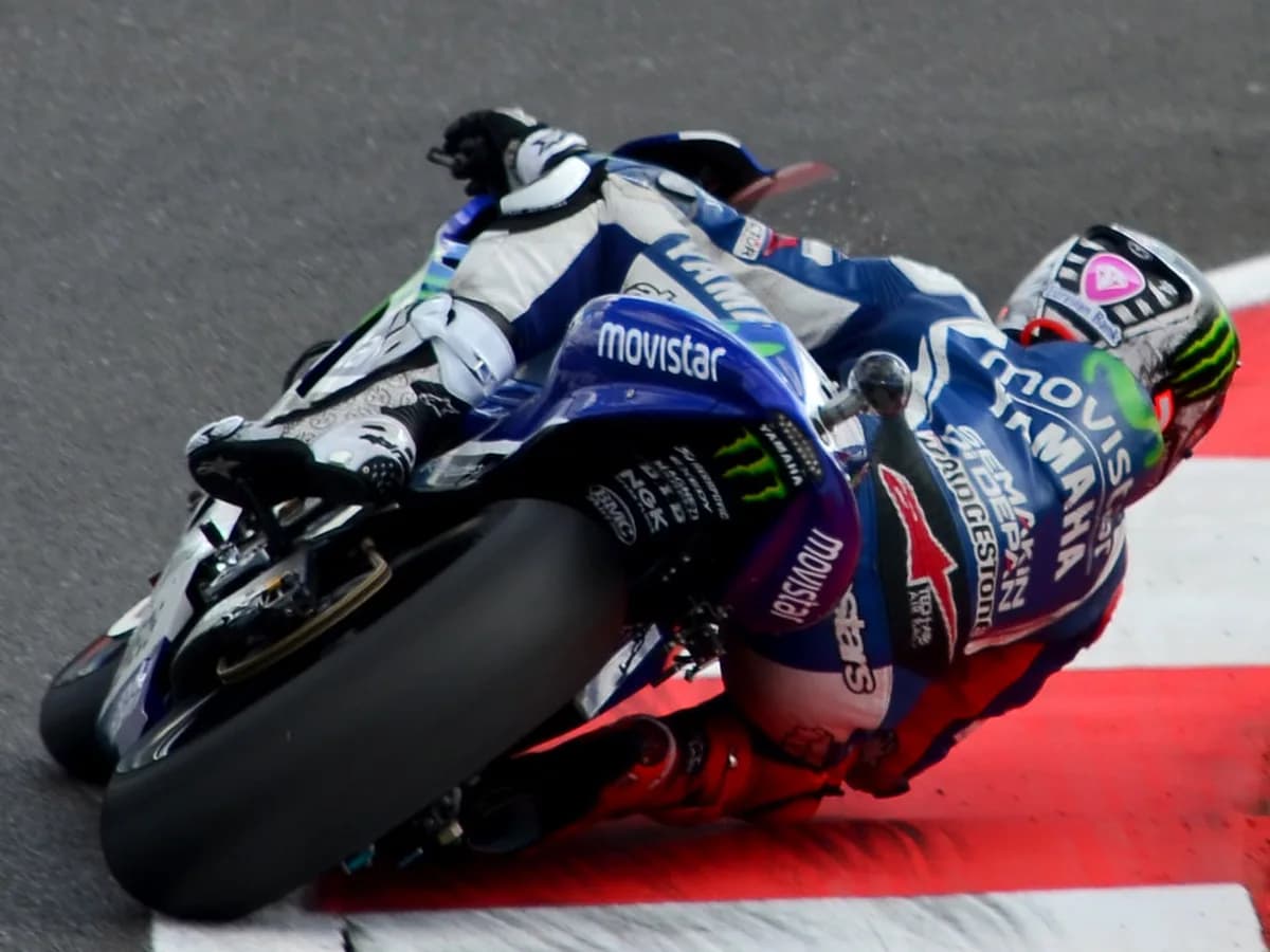 MotoGP rider cornering hard during a title-race weekend