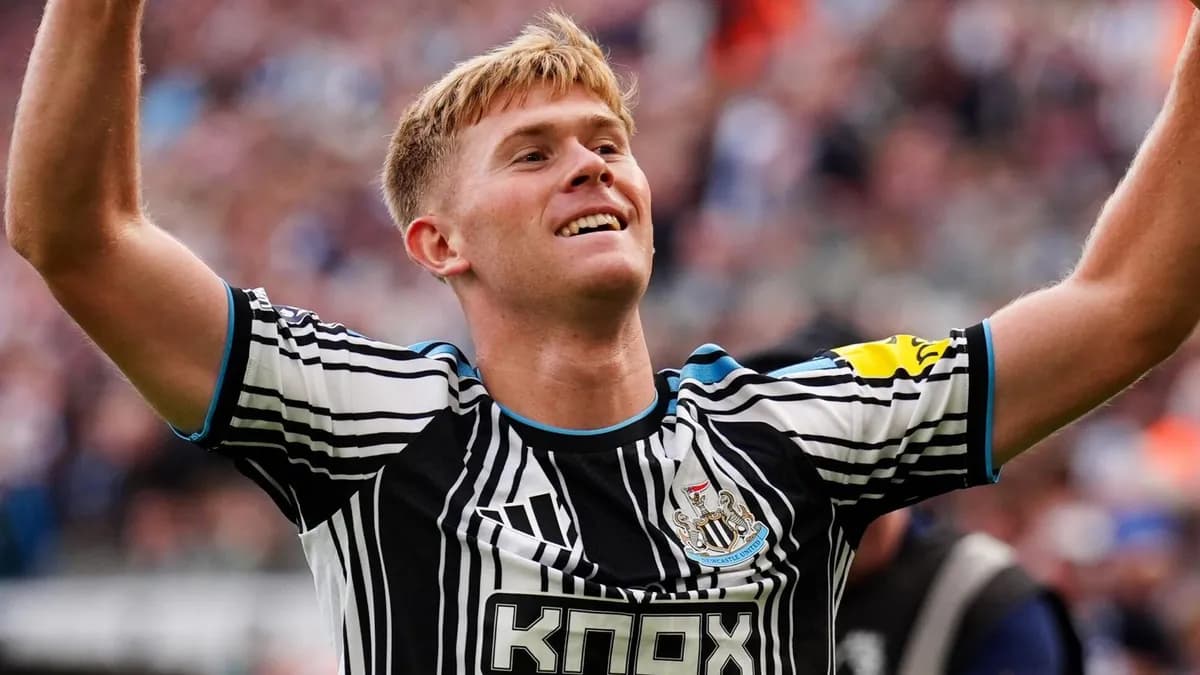 Newcastle United defender Lewis Hall smiles with both arms raised in celebration at St James’ Park after scoring against Hull City