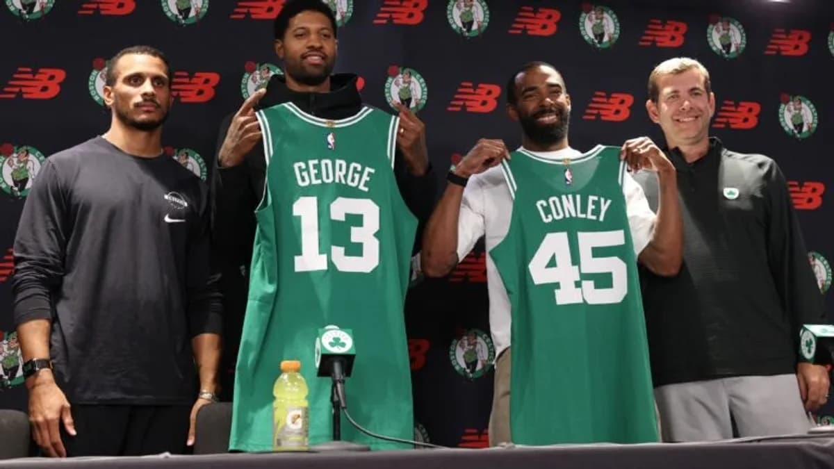 Paul George and Mike Conley hold Celtics jerseys alongside Joe Mazzulla and Brad Stevens