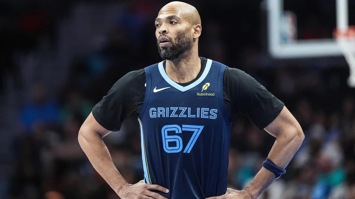 Taj Gibson stands with his hands on his hips in a Memphis number 67 jersey