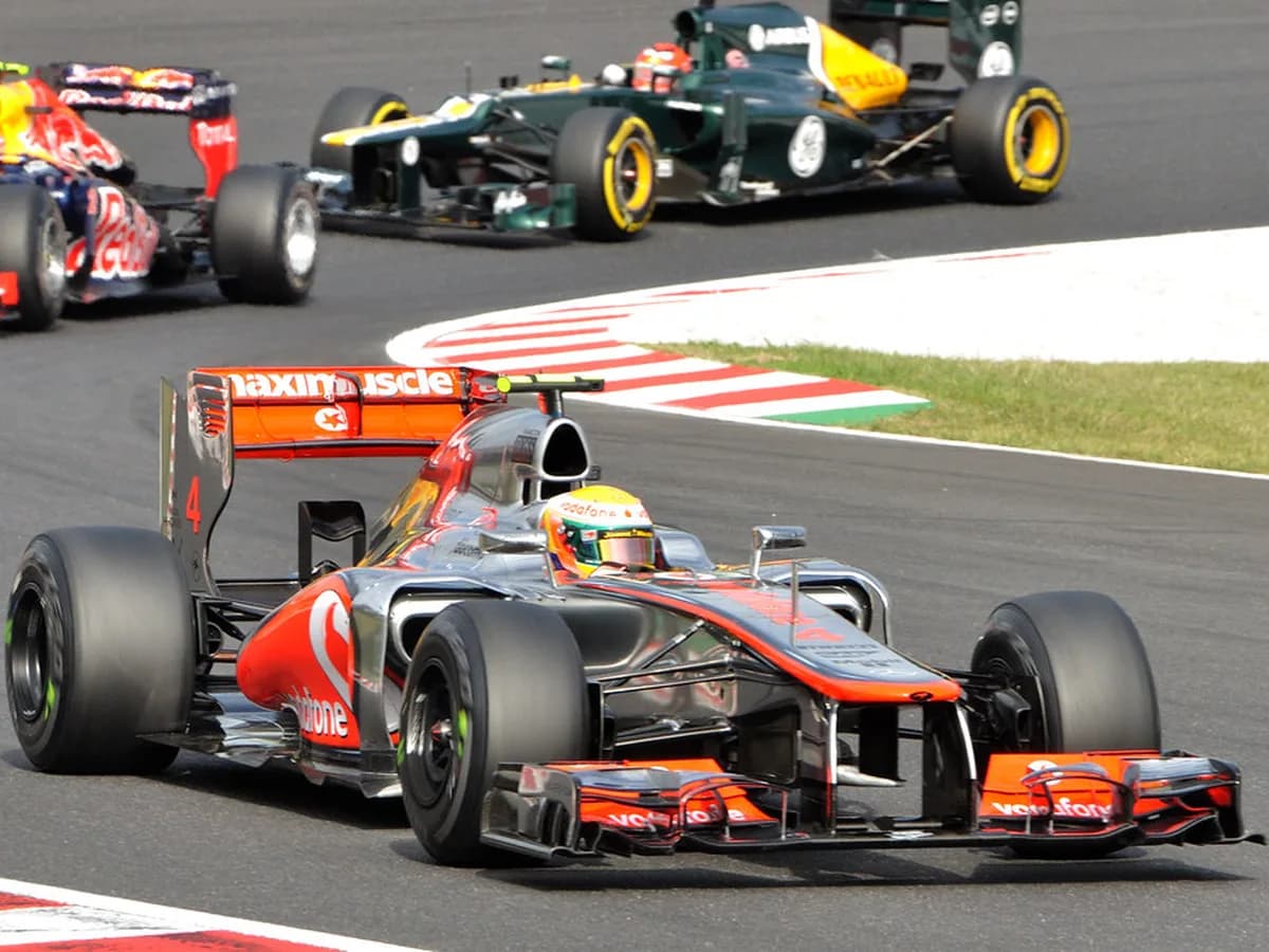 F1 car leaning through a fast corner during a Grand Prix