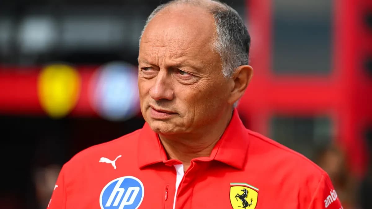 Ferrari team principal Fred Vasseur in a red Ferrari team shirt looks on thoughtfully in the Formula 1 paddock