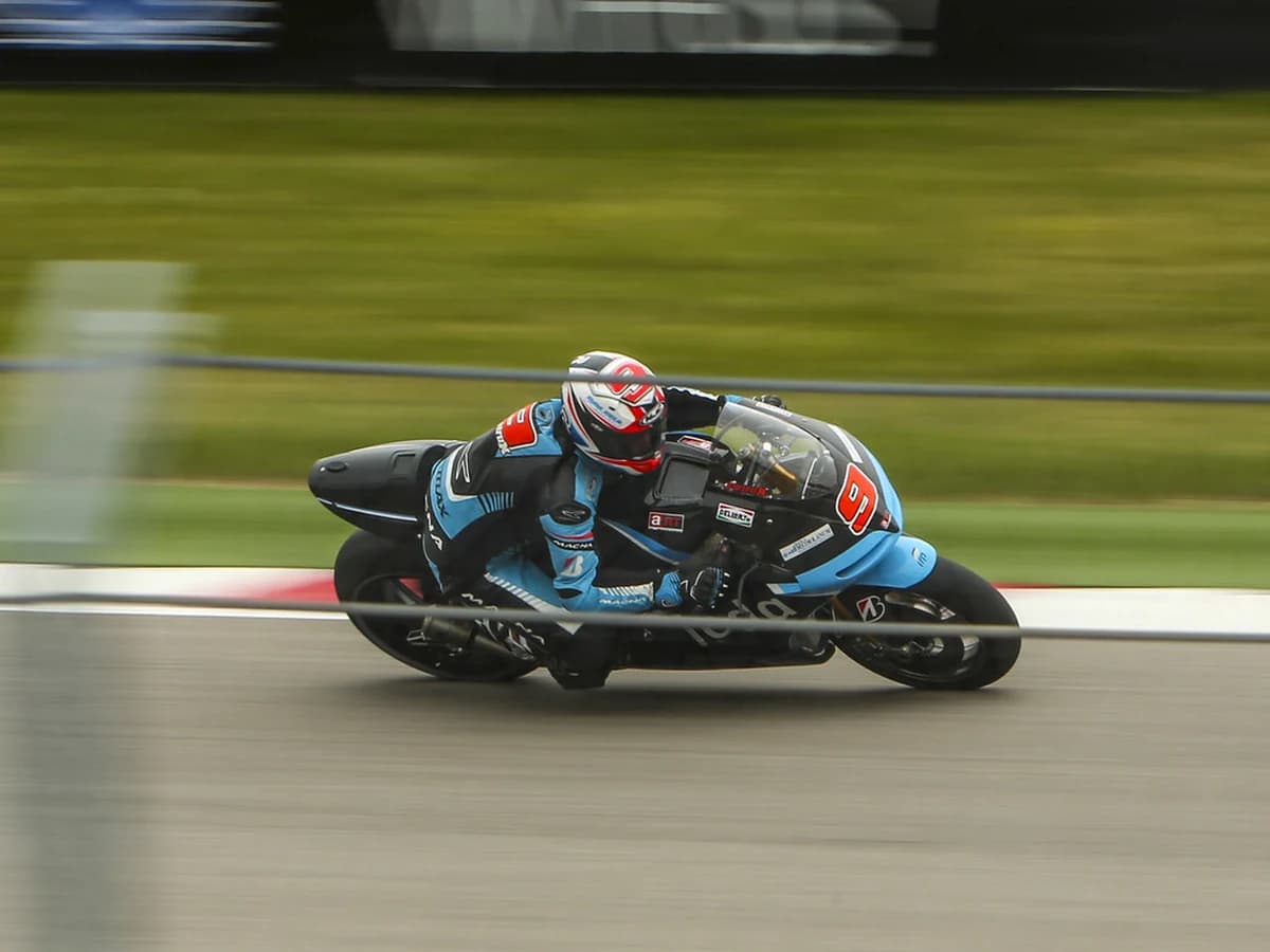 MotoGP rider leaned over through a fast corner, knee down