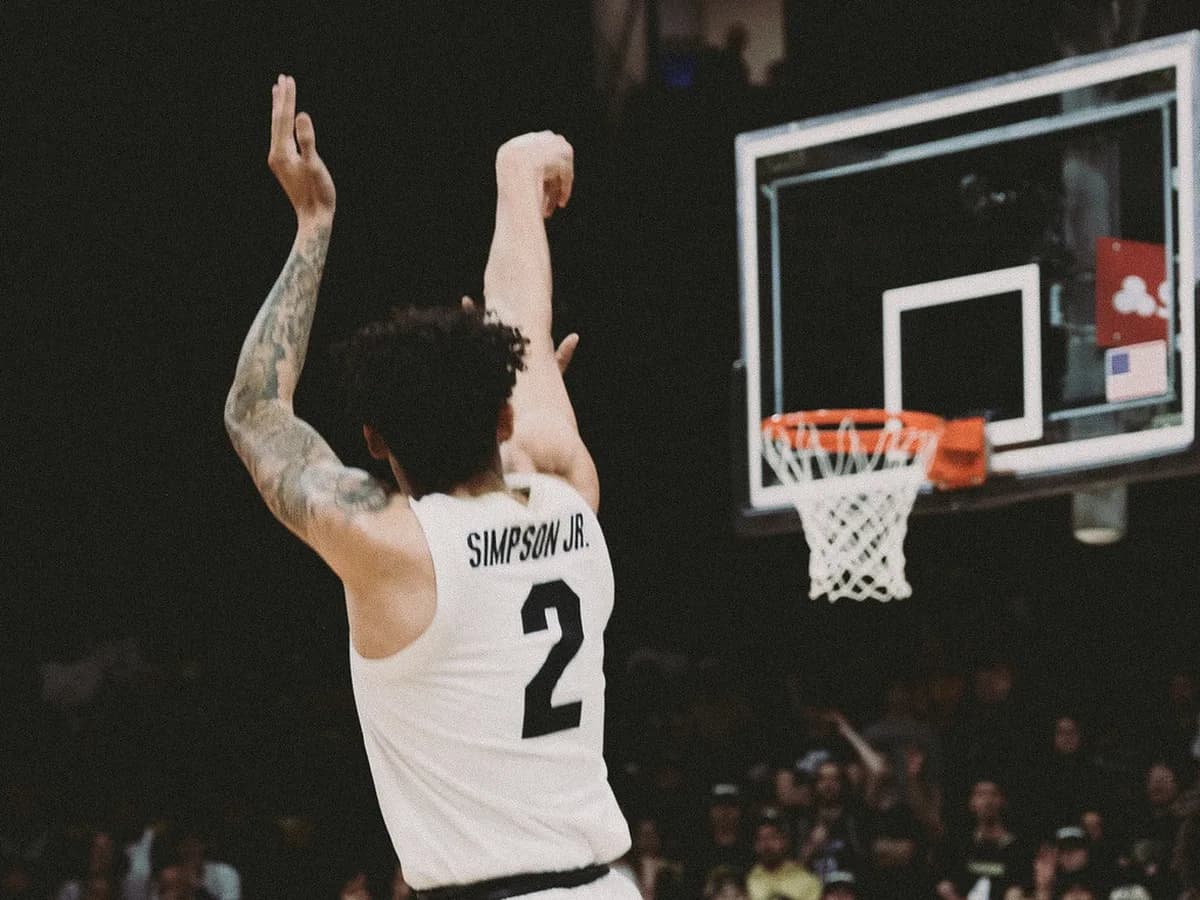 NBA player releasing a three-point shot late in the clock