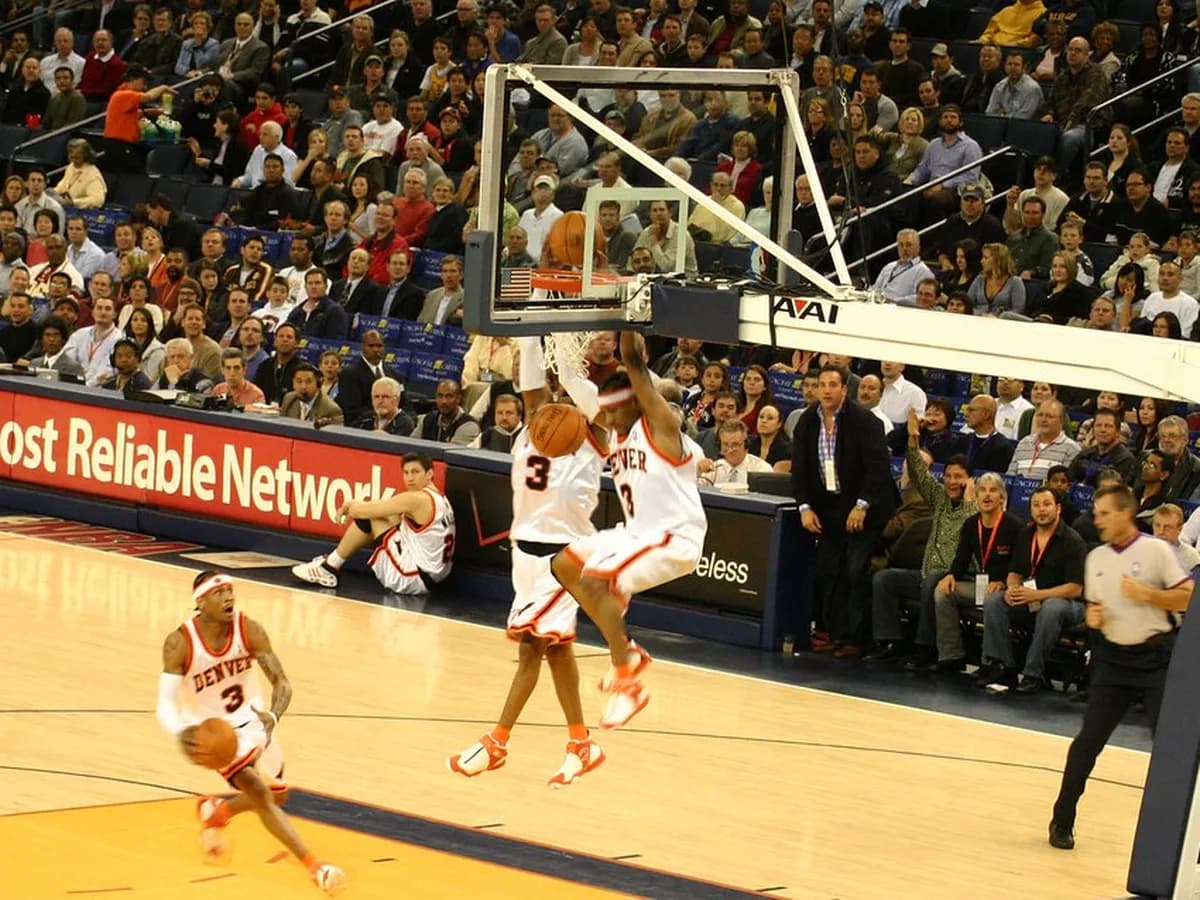 NBA guard driving to the basket against a defender